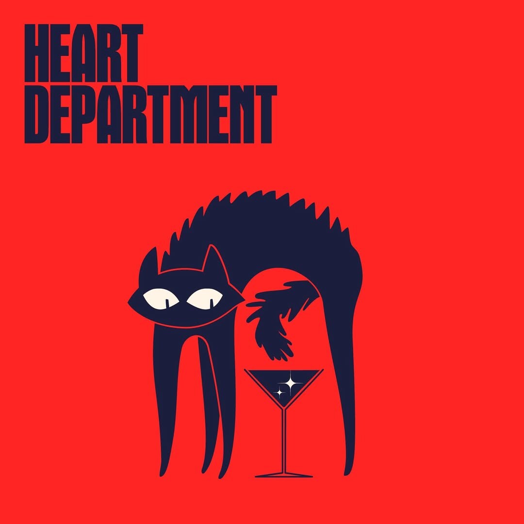 Heart Department poster — the HEART DEPARTMENT wordmark stacked top-left in deep navy, with the brand's signature wide-eyed cat illustration leaning over a martini glass on a brand-red field.